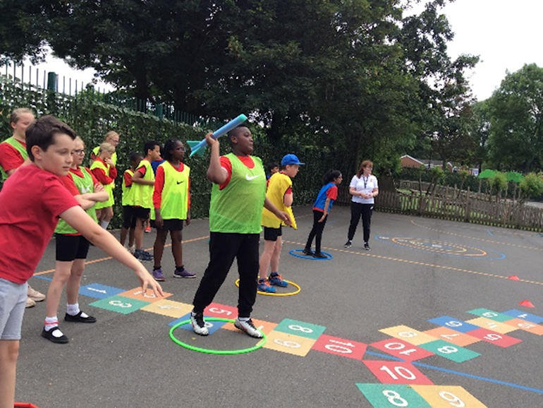 Children in the playground throwing the javelin